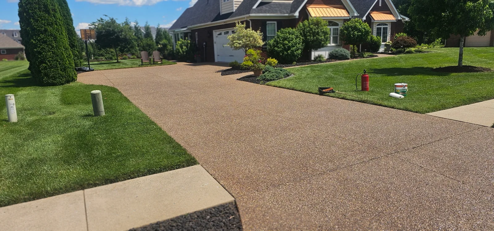 Clean driveway and front approach of a Louisville home, photographed from the street